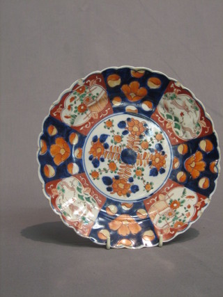 A 19th Century Japanese Imari porcelain plate with lobed borders and panelled body decorated flowers 8 1/2" (chips to rim)