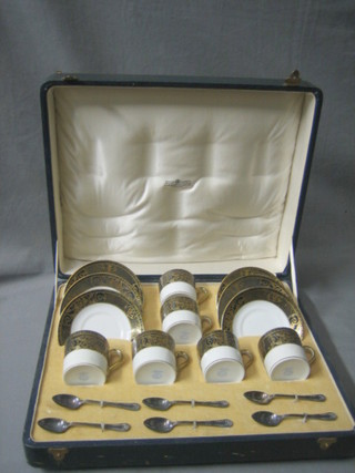 A 6 piece Noritake porcelain coffee service together with 6 silver plated coffee spoons, contained in a presentation case retailed by Alexander Clark & Co.