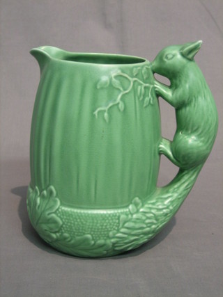 A green glazed Sylvac jug the handle in the form of a squirrel, the base impressed 1959 Sylvac 8"