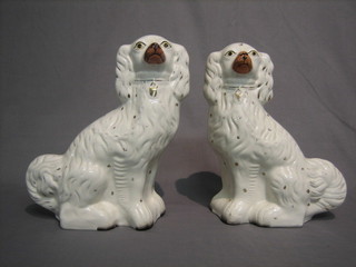 A pair of Staffordshire figures of seated Spaniels 12"