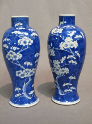 A  pair of Oriental blue and white vases of baluster form decorated Prunus, the base with small character mark 11"