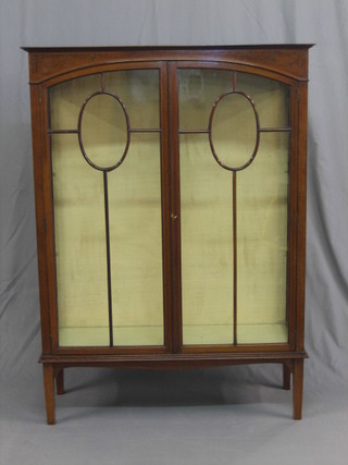 An Edwardian inlaid mahogany display cabinet, the interior fitted adjustable shelves enclosed by astragal glazed panelled doors, raised on square tapering supports 39"