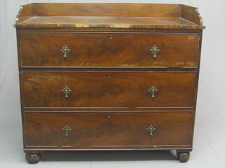 A 19th Century mahogany wash stand with three-quarter gallery, the base fitted 3 long drawers, raised on bun feet, 43"