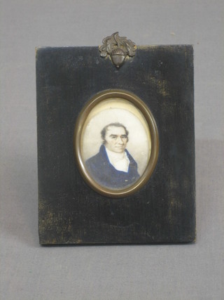 An 18th/19th Century portrait miniature on ivory of a gentleman wearing a blue jacket 2 1/2" oval, contained in ebony frame