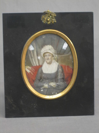 An 18th Century portrait miniature on ivory of Mrs E Thorse sat on a settee wearing a gown and bonnet 4 1/2" (slight crack to ivory) contained in an ebony frame