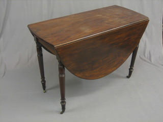 A 19th Century mahogany oval gateleg dining table raised on turned supports ending in brass caps and castors 42"