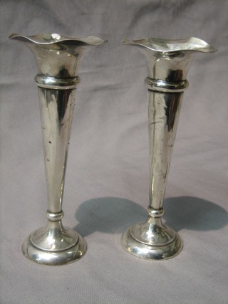 A pair of silver trumpet shaped vases raised on circular spreading feet, Birmingham 1912 8" (some dents)