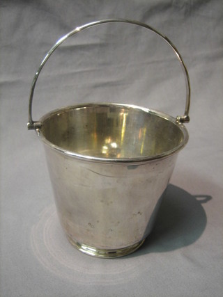 A silver plated ice pail with swing handle