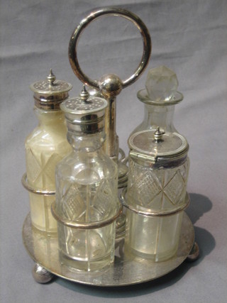 A circular silver plated cruet frame with 5 cut glass bottles