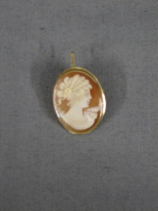 A modern shell carved cameo brooch contained in a gold mount