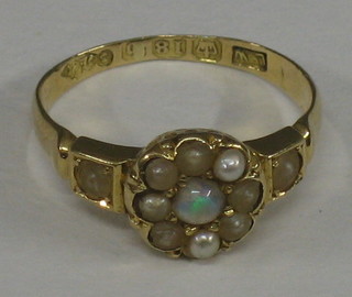 A Victorian 18ct gold dress ring set an opal surrounded by demi-pearls