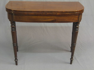 A Georgian D shaped mahogany card table with ebony stringing, raised on turned supports 36"