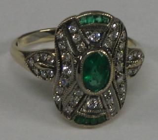 A lady's 18ct gold dress ring set emeralds and diamonds