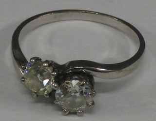 A lady's 18ct white gold or platinum crossover engagement ring set 2 diamonds (one slightly yellow)