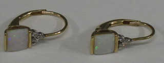A pair of lady's earrings each set an opal and white stones