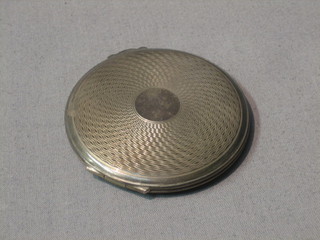 An Art Deco circular silver compact with engine turned decoration, Birmingham 1946