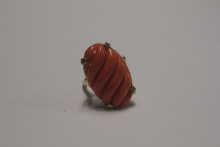 A lady's 9ct gold dress ring set an oval cut coral