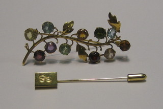 A gilt metal brooch set hardstones and a gilt metal stick pin