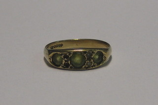 A 9ct gold dress ring set green and white stones