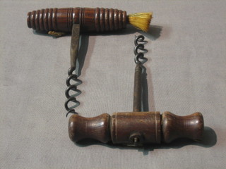 A 1930's steel corkscrew with turned wooden handle and 1 other