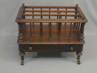 A Victorian mahogany 3 section Canterbury with turned columns, the base fitted a drawer and raised on turned supports 24"