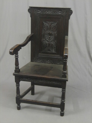 A Victorian carved oak Wainscot chair, raised on turned and block supports