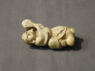 An Oriental carved ivory figure of a standing musician with drum 2"