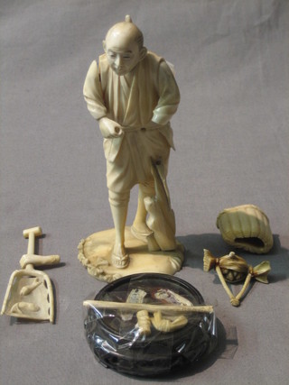A carved ivory figure of a standing fisherman 6" (f)