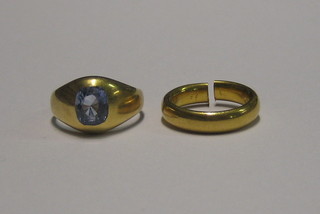 A high carat gold wedding band (cut) and a gilt coloured signet ring set a blue stone