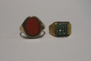 A gold signet ring set a hardstone and a gold dress ring set blue stones