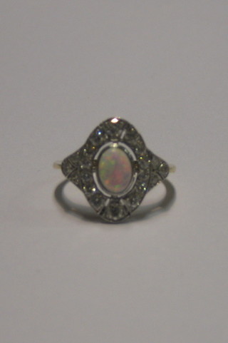 A lady's 18ct gold dress ring set an oval cut opal surrounded by numerous diamonds (approx 0.60ct)