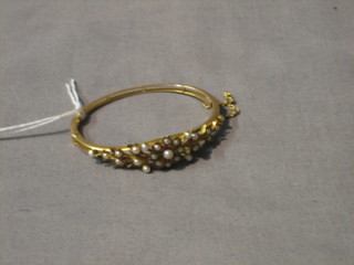 An Edwardian floral gold bangle set demi-pearls