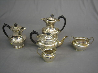 A silver plated 4 piece oval tea service comprising teapot, hotwater jug, twin handled sugar bowl and cream jug and 1 other plain hotwater jug
