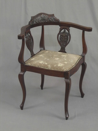 A Victorian carved walnut corner chair with splat back and upholstered seat, raised on cabriole supports
