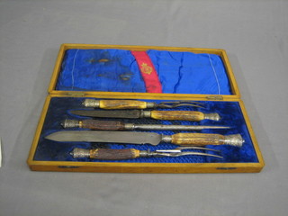 A Victorian 5 piece carving set with stag horn handles contained in a mahogany case