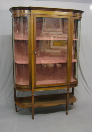 An Edwardian inlaid mahogany D shaped display cabinet, the interior fitted shelves enclosed by glazed panelled doors, raised on square tapering supports ending in spade feet with undertier (1 back leg f and r) 56"