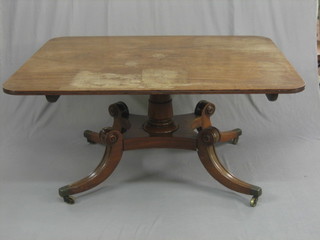 A handsome Georgian mahogany snap top breakfast table raised on a turned column with triform base raised on splayed feet ending in brass caps and castors 57"