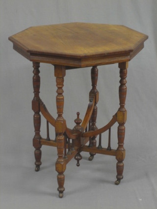 An Edwardian walnut octagonal occasional table, raised on turned supports united by an X framed stretcher 24"