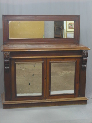 A Victorian mahogany sideboard with raised mirrored back, the base fitted cupboards enclosed by arch shaped panelled doors, raised on a platform base 55"