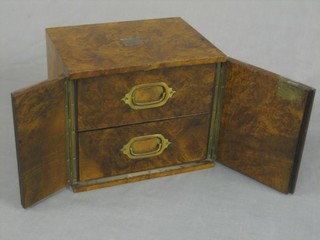 A Victorian figured walnut table top cigar box, the interior fitted 2 drawers enclosed by a panelled door with Bramah lock 12"