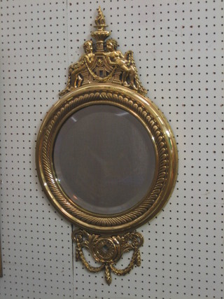 A handsome 19th Century circular bevelled plate wall mirror contained in a cast brass frame surmounted by 2 figures sat beneath an urn 15"