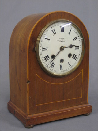 An Edwardian 8 day chiming bracket clock with Roman numerals by TRE of 310 Woolworth Road London, contained in an inlaid mahogany arch shaped case