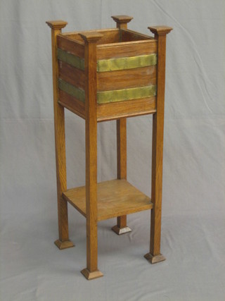 An Edwardian Art Nouveau oak and brass banded square jardiniere stand with undertier 13"