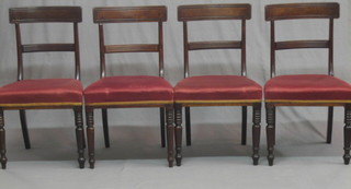 A set of 4 Regency bar back dining chairs with plain mid rails and upholstered seats, raised on turned supports