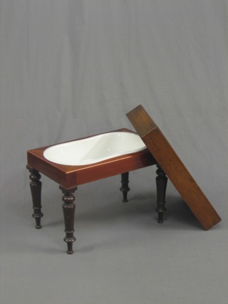 A Victorian mahogany bidet complete with china liner, raised on turned supports 21" (5" split to the top)