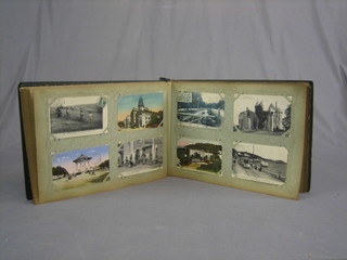 A green album of various French colour and black and white postcards