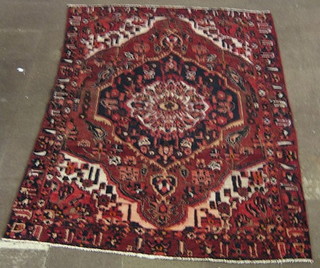 A contemporary Bakhtiari red ground rug with central medallion 117" x 79"