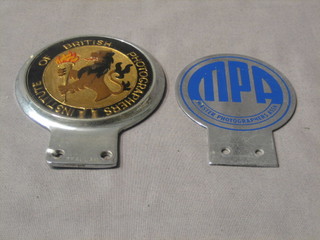 An Institute of British Photography car badge and a Master Photographer's Association car badge
