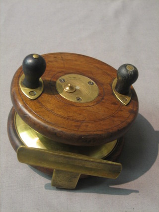 A wooden and brass frog back fishing reel 4 1/2" 