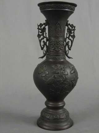 A 19th Century Oriental bronze twin handled vase of club form, raised on a circular spreading foot 14"